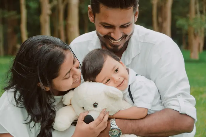 a man and woman holding a baby